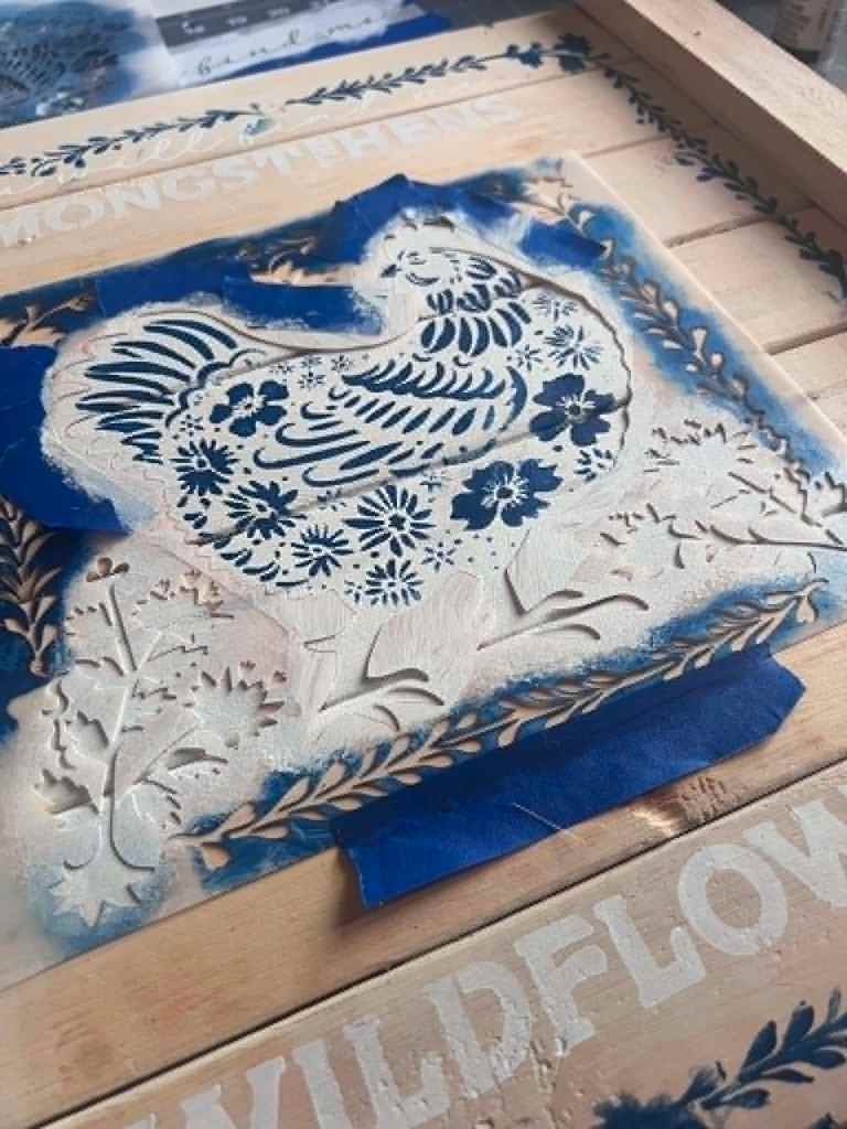 Close-up of the navy floral and feather detail freshly revealed on the white hen 