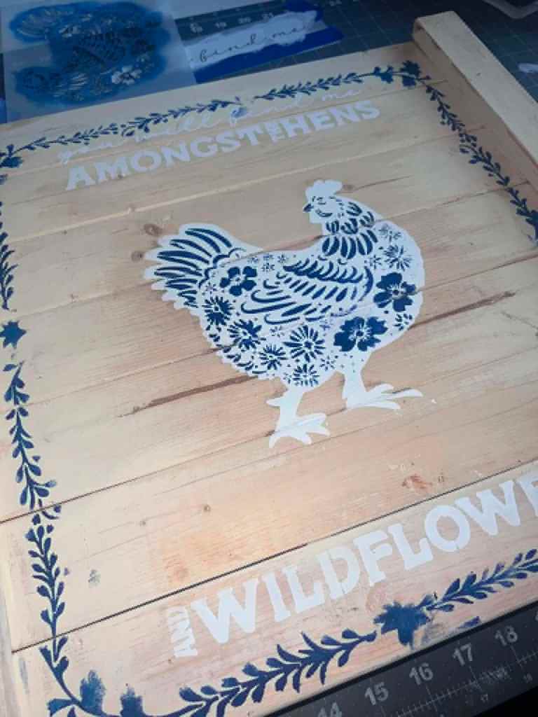 Angled view of the finished floral hen detail on the wood board 